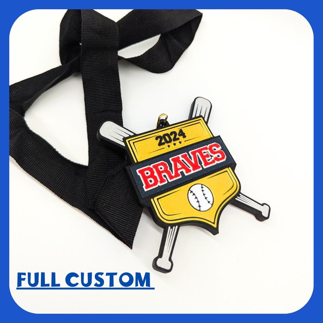 Customizable baseball medal featuring two silver crossed bats, a gold shield with the word in bold red and white letters The medal is attached to a black ribbon, highlighting the option for personalizing team names, colors, and details. team gift