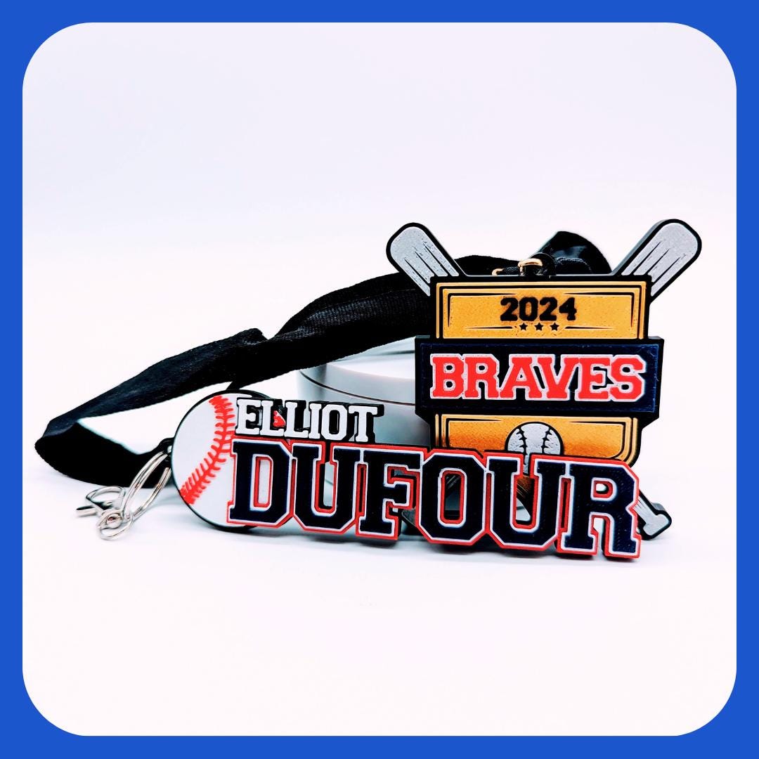 Custom baseball medal featuring the team name in bold red and white letters on a gold shield with crossed silver bats, along with a personalized name tag with a baseball icon. The medal and tag are attached to a black ribbon.gift kit baseball player