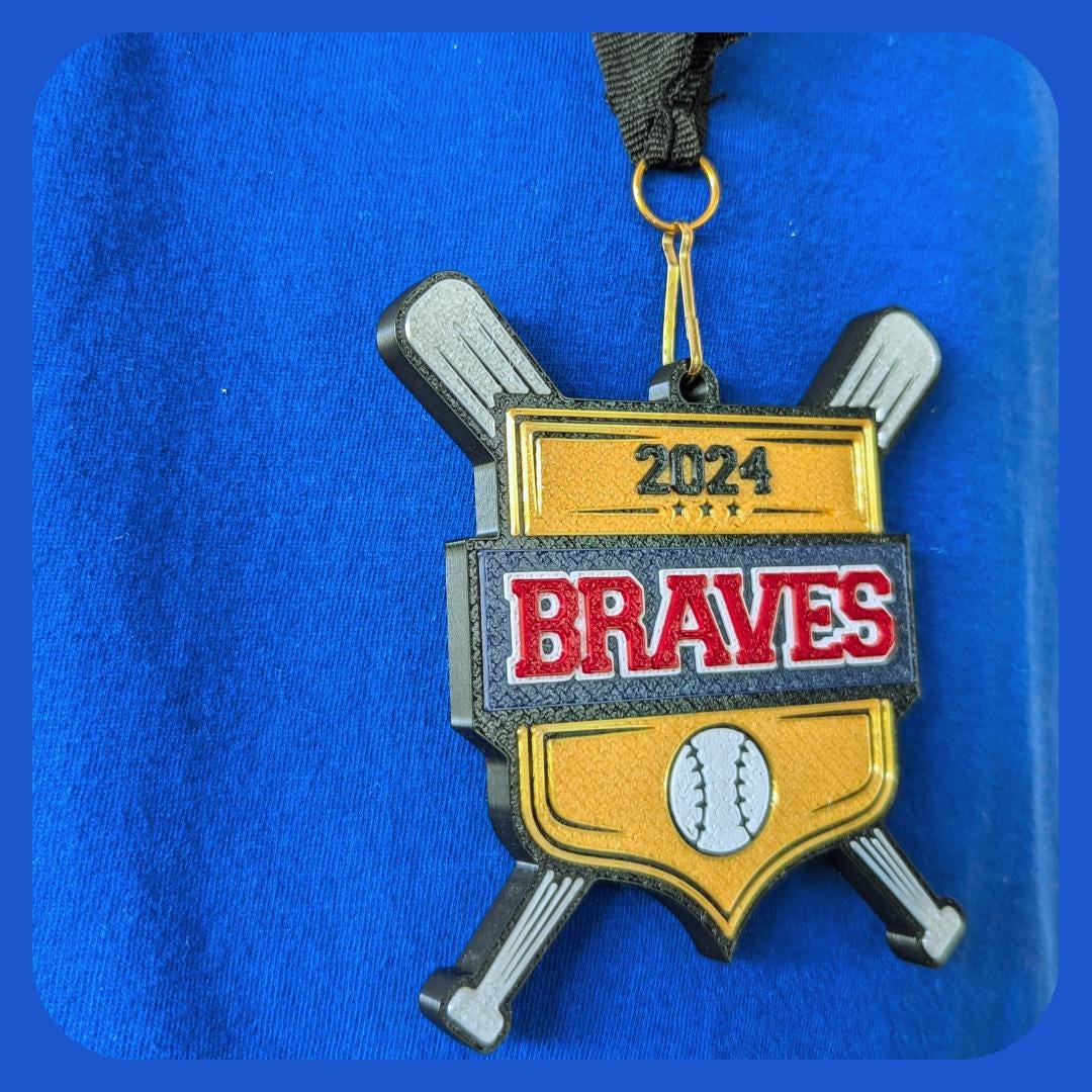 The custom medal includes a baseball icon and two crossed silver bats, hanging on a black ribbon against a blue background